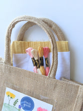 Load image into Gallery viewer, Jute bag embroidery kit includes cotton fabric and DMC thread.

