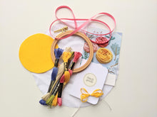 Load image into Gallery viewer, Beechwood hoop embroidery kit includes felt, thread, need and ribbon. Pink, blue, yellow, green and cream colors.
