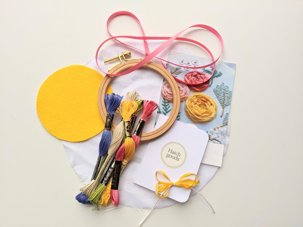 Beechwood hoop embroidery kit includes felt, thread, need and ribbon. Pink, blue, yellow, green and cream colors.