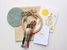 Load image into Gallery viewer, Embroidery kit includes felt backing, 4 inch beechwood hoop, vintage ribbon, DMC thread, needle and cotton fabric.
