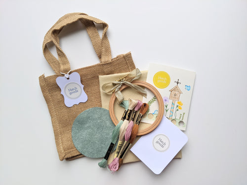 Jute bag embroidery kit includes 4 inch beechwood hooo, felt backing, DMC floss, needle and needleminder card and vintage ribbon.