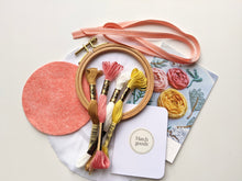 Load image into Gallery viewer, 4 inch beechwood hoop embroidery kit includes peach felt backing, needle, peach ribbon and DMC floss colors, peach, yellow, cream and brown.
