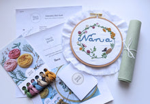 Load image into Gallery viewer, Nana embroidery kit includes DMC floss in blue, yellow, green, pink, cream, brown and black. Includes back stitch, satin stitch, french knot and stem stitch.
